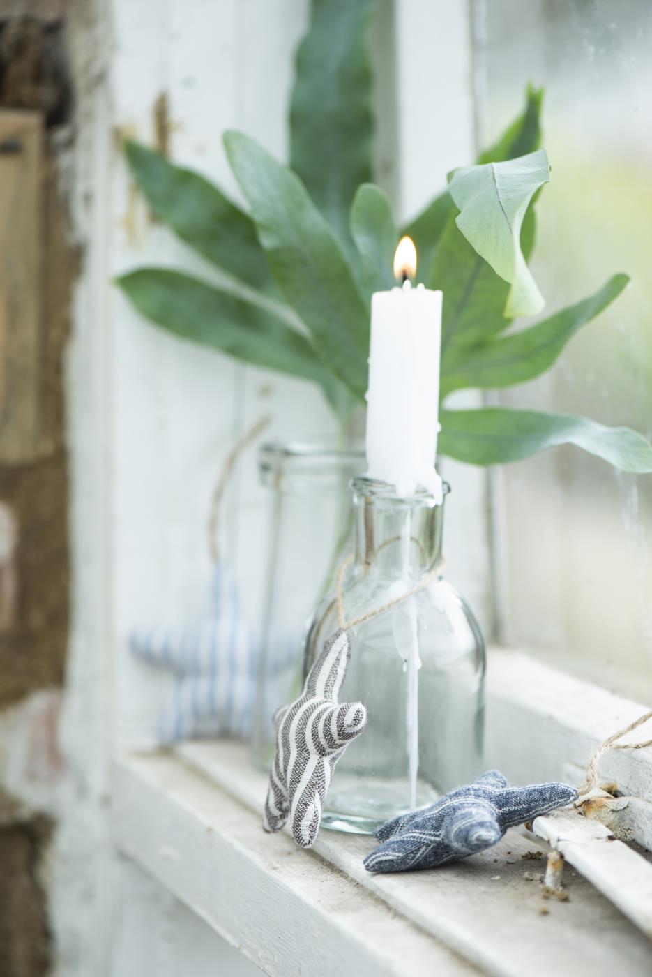 Apotekerglas fra Ib Laursen med hvidt lys og stjerne omkring