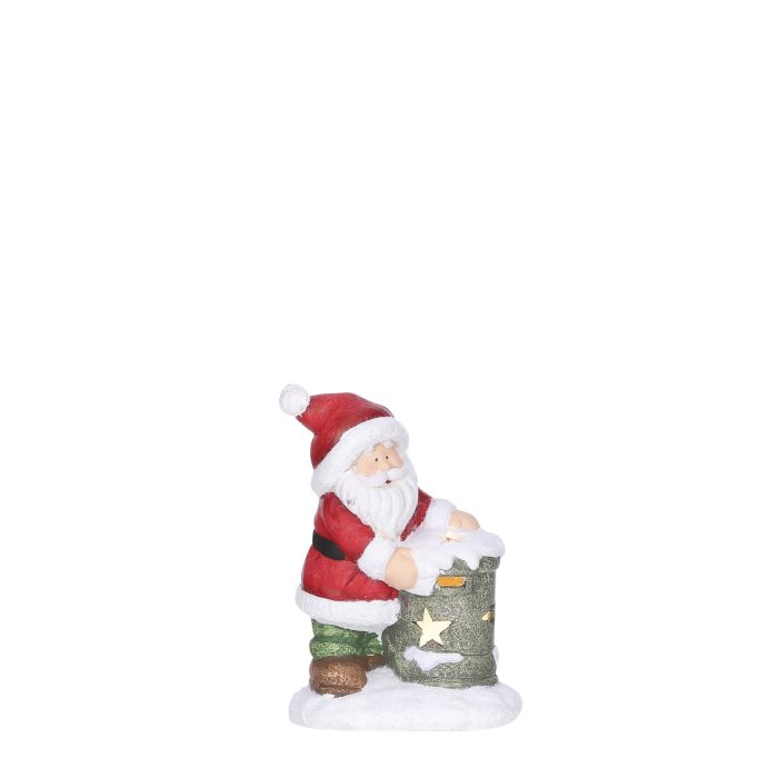 Julemand i flotte julefarver står ved postkassen med juleønsker. Postkassen lyser igennem stjerner.