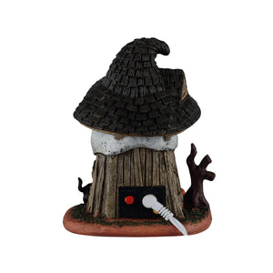 Bagsiden på Witch's Skull Hut bygning med lys til Halloween dekoration fra Lemax